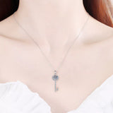 1 Carat 925 Sterling Silver Moissanite Key Pendant Necklace worn by a woman, showcasing elegant jewelry.