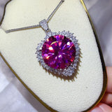 20 Carat Moissanite 925 Sterling Silver Pendant Necklace on display with a brilliant pink center stone.