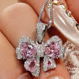 Zircon Bow Pendant Necklace showcasing a beautiful pink butterfly design, adorned with shimmering zircons.