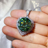 20 Carat Moissanite 925 Sterling Silver Pendant Necklace with green gemstone on hand.