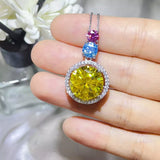 11.5 Carat Moissanite 925 Sterling Silver Necklace showcased in hand with vibrant yellow and blue stones.