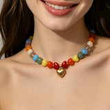 Colorful Heart Pendant Beaded Collarbone Necklace worn by a model, showcasing vibrant colors and gold accents, bijoux, femme.