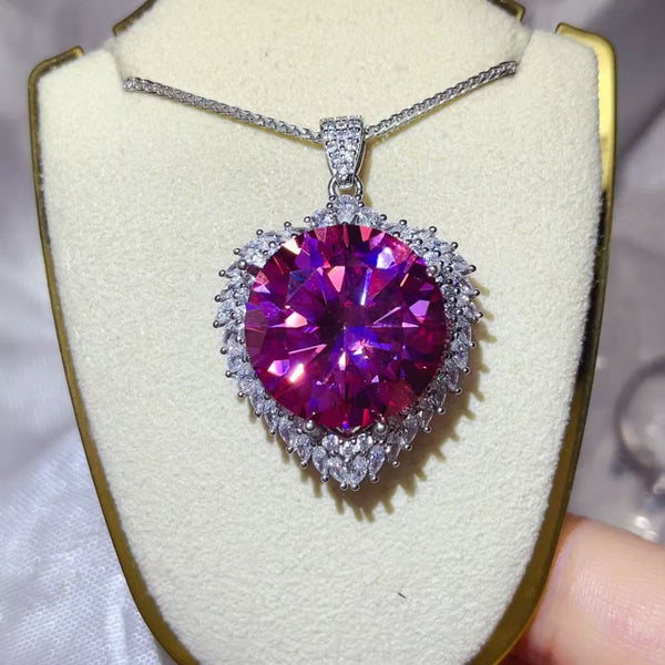 20 Carat Moissanite 925 Sterling Silver Pendant Necklace featuring a stunning pink gemstone on a display.